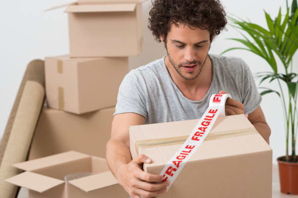 A man packing boxes to store at Baton Rouge Self Storage