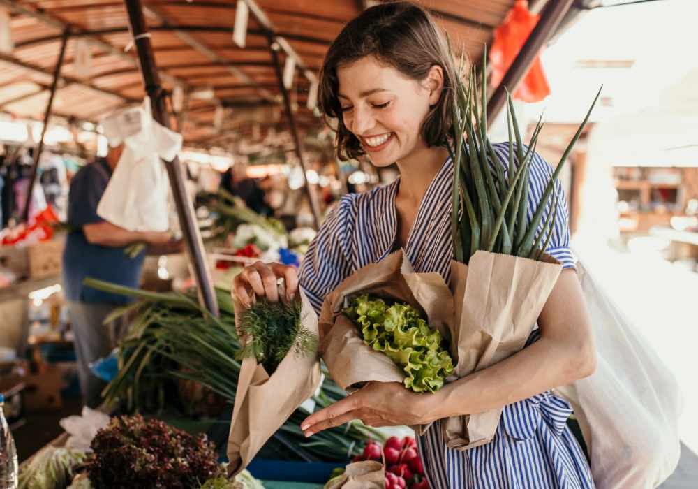 Woman buying flowers at a market near The Heron Downtown in Baton Rouge, Louisiana