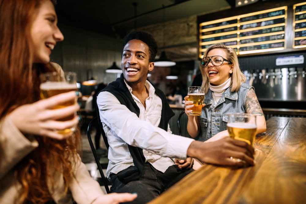 Friends enjoying drinks at a local bar near Springfield Apartments in Murfreesboro, Tennessee