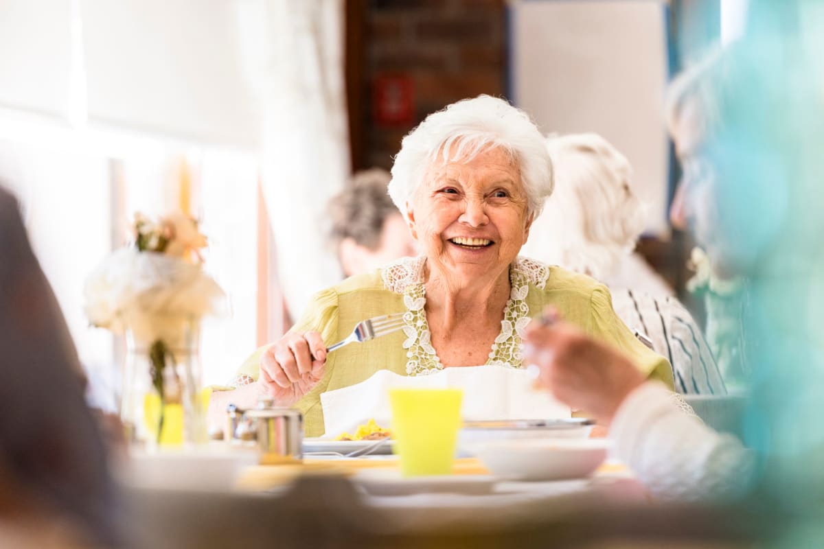 A memory care resident in the dining hall at The Oxford Grand Assisted Living & Memory Care in Kansas City, Missouri