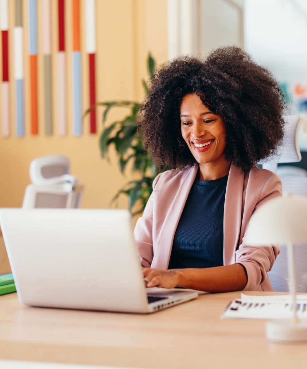  Team member working on her laptop at ARTISAN Management Group in Des Moines, Iowa