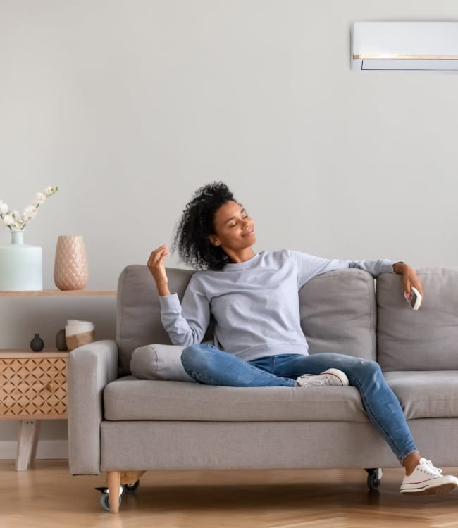 A resident relaxing in her living room at New Shiloh Village Family Apartments in Baltimore, Maryland