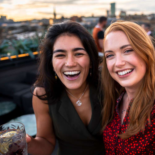 Friends celebrating on the resident rooftop lounge at Solaire 1150 Ripley in Silver Spring, Maryland