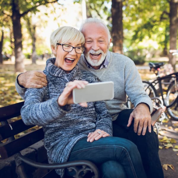 Residents taking a selfie on a bench at Quail Park at Morrison Ranch in Gilbert, Arizona