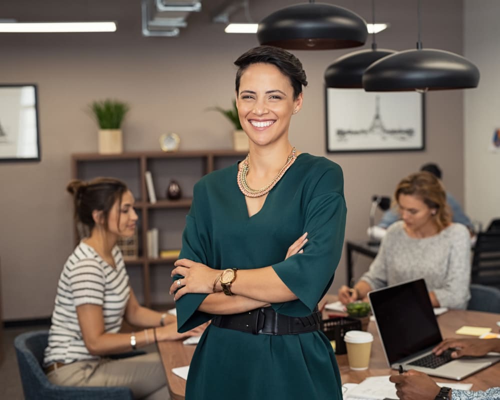 Happy employee posing for a photo at Olympus Property in Fort Worth, Texas