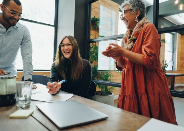 Team members laughing during a meeting at Case & Associates