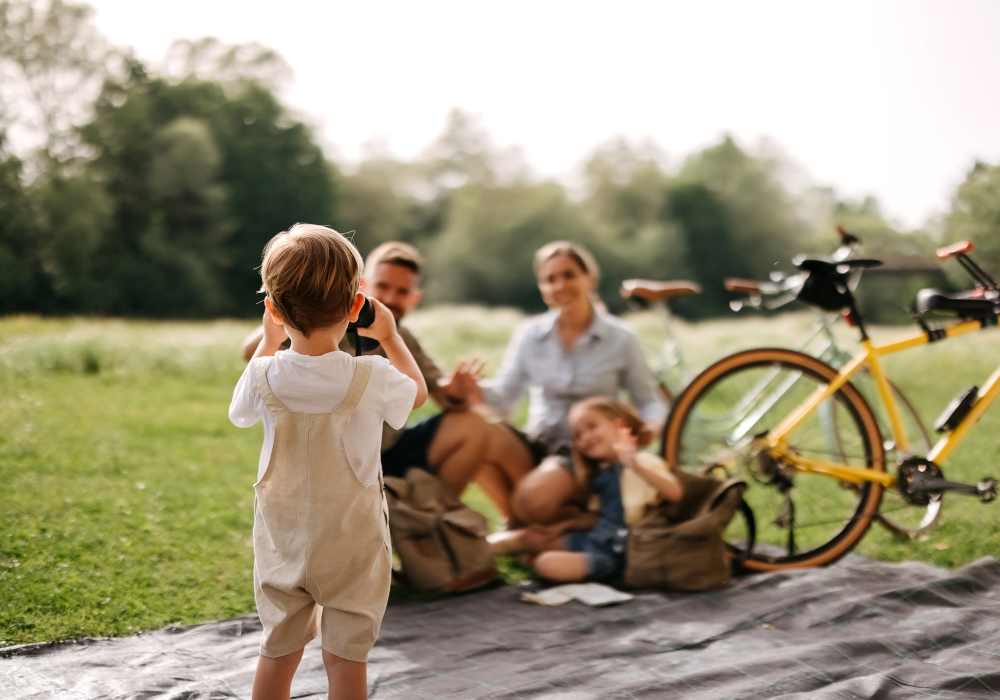 Happy family sitting in a park near Main Street Vista in Holly Springs, North Carolina