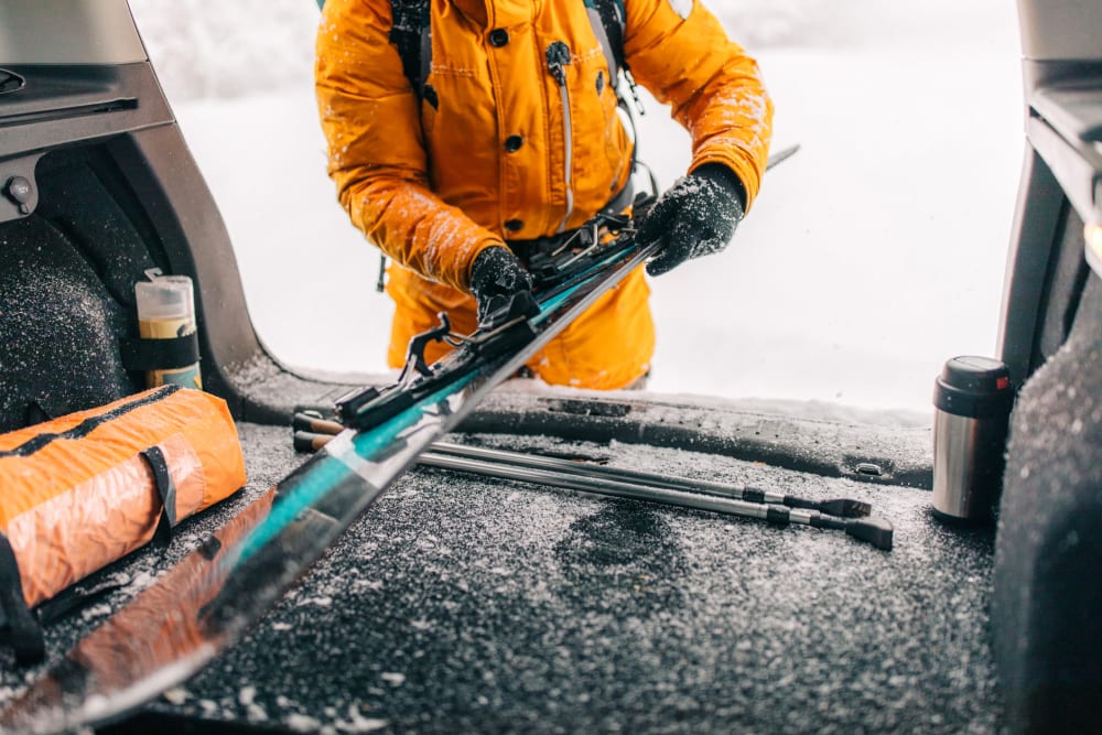 A customer putting skis in a car near Storage Star South College in Fort Collins, Colorado