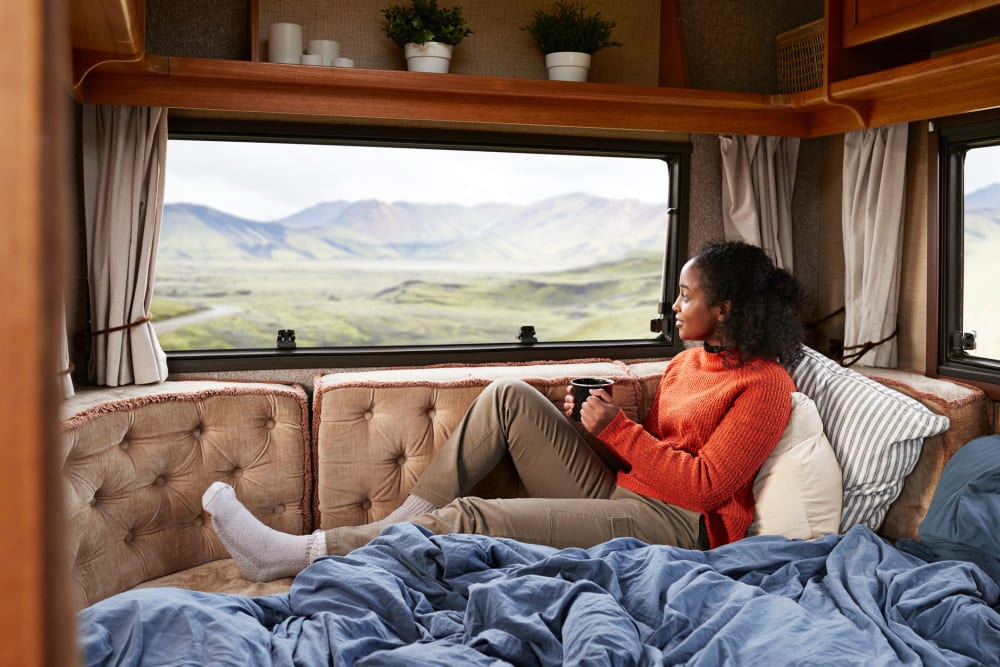 Interior of a small trailer with a woman relaxing by the back window near BestBox Storage - New Caney in New Caney, Texas