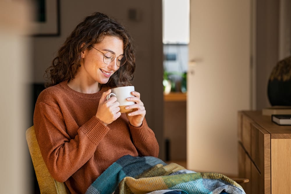 Resident drinking coffee at Northcreek in Phenix City, Alabama