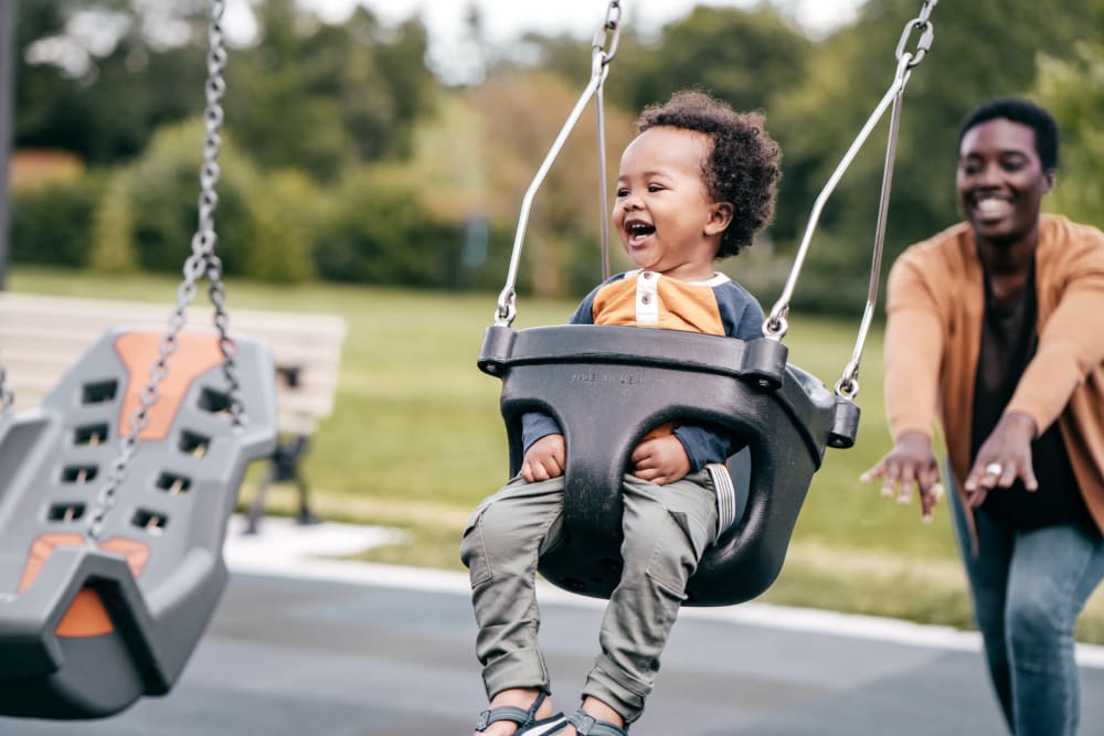 Child in swing at playground at Chesterfield Flats, North Chesterfield, Virginia