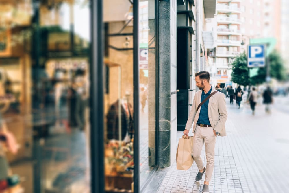 Man walking down a sidewalk window shopping near 1510 Belleville in Richmond, Virginia