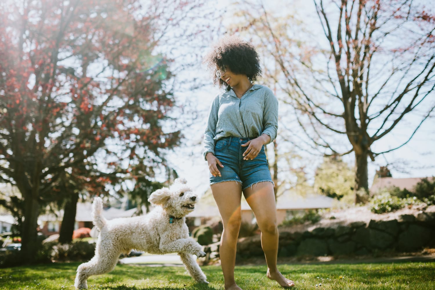 Resident playing with her dog outside at Regents West at 26th in Austin, Texas