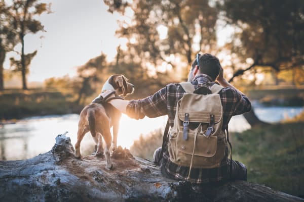 Man and his pet in adventures by the river near Environs Residential Rental Community in Westminster, Colorado