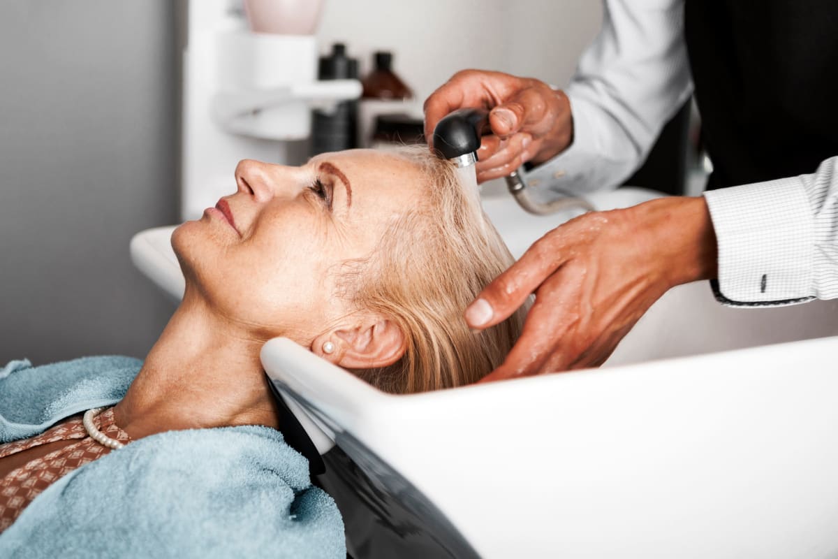 Resident getting her hair done at the onsite salon at The Claiborne at Gulfport Highlands in Gulfport, Mississippi.