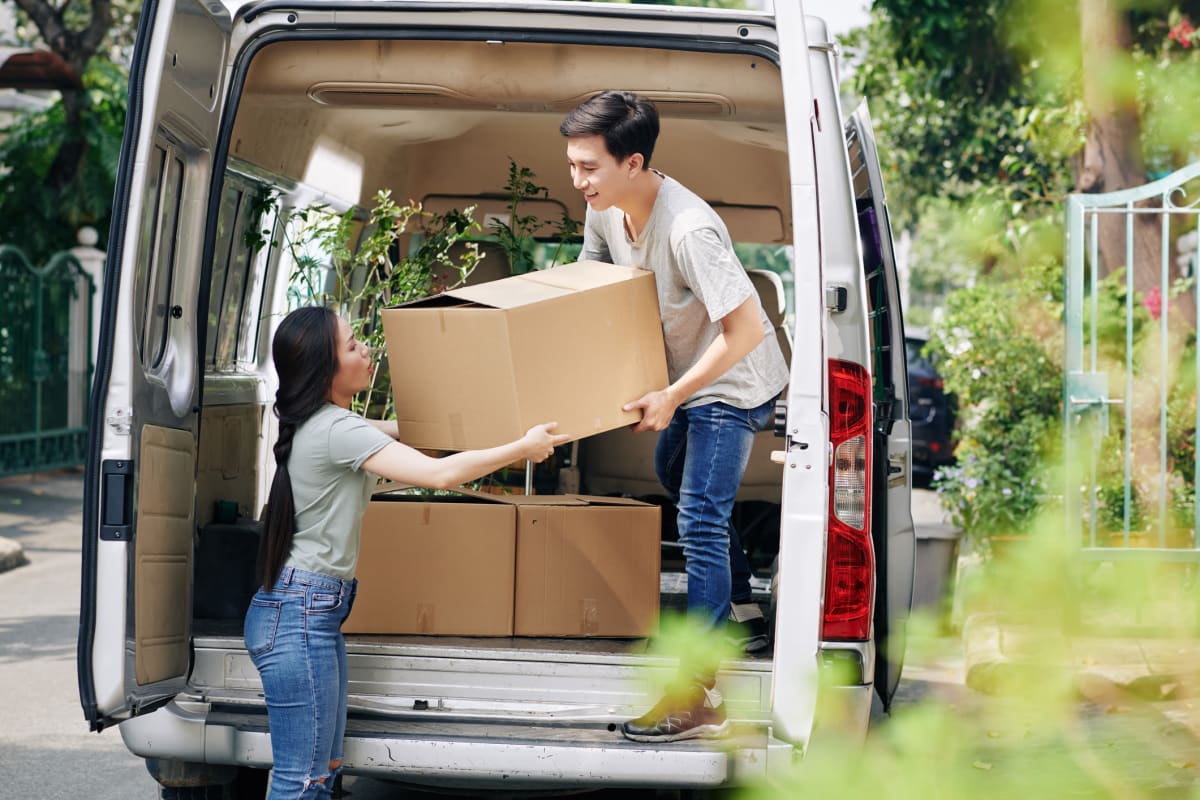 Customers packing boxes into a car to store at Red Dot Storage in Lafayette, Louisiana