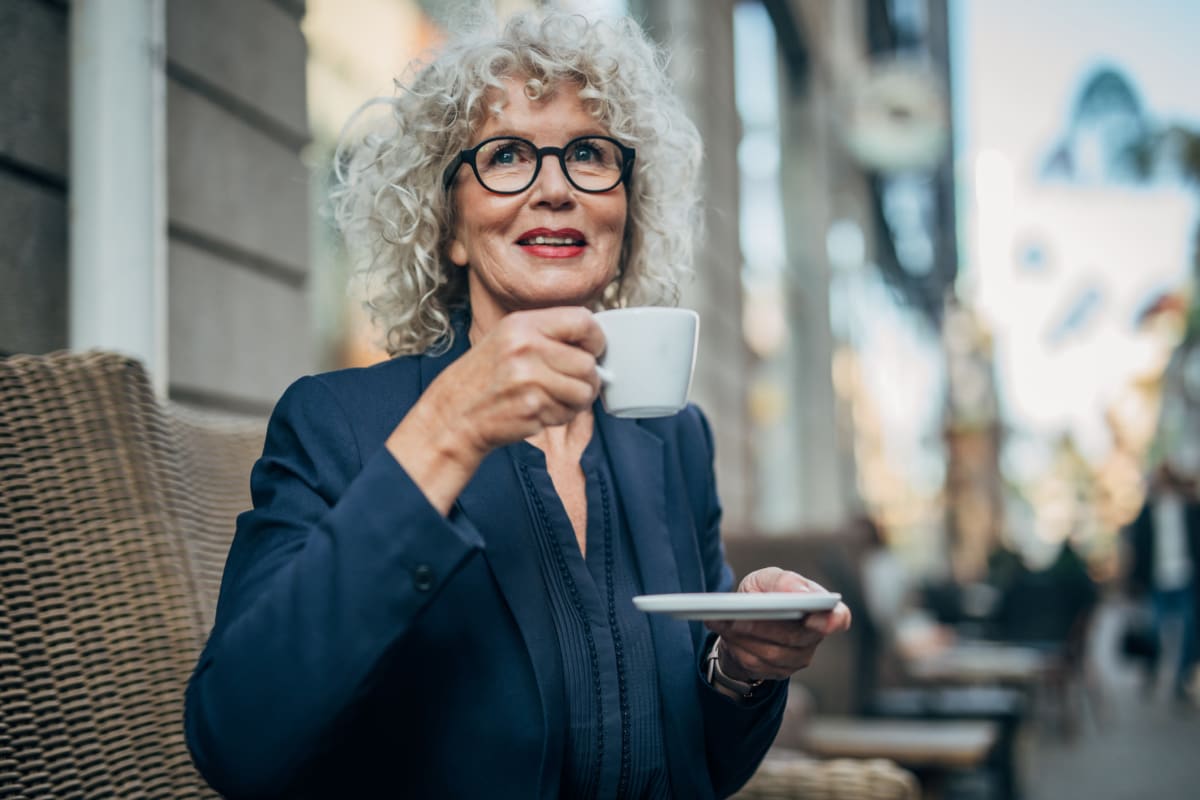 Resident sitting outside drinking coffee at Citrus Place in Riverside, California