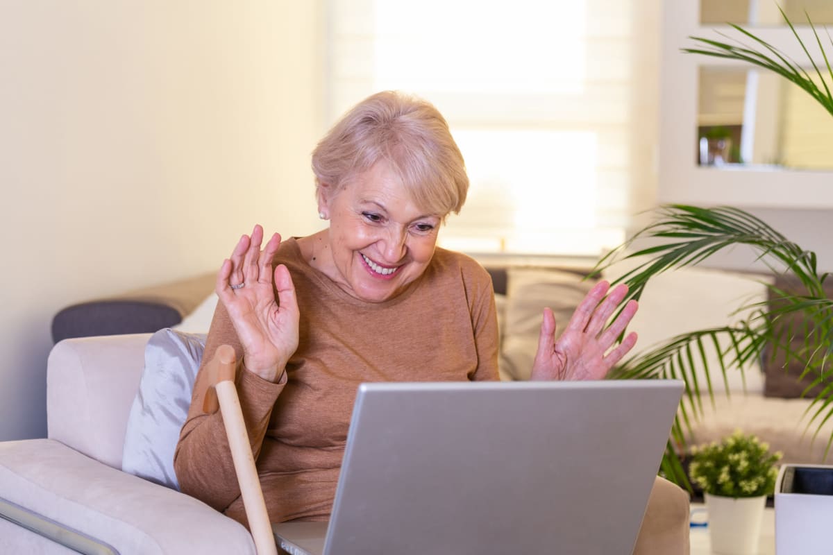 A resident video chatting with her grand children at The Oxford Grand Assisted Living & Memory Care in McKinney, Texas