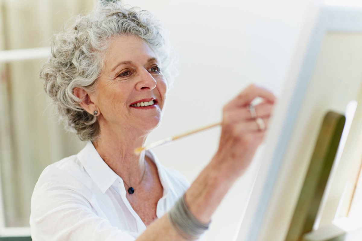 A resident painting at Oxford Villa Active Senior Apartments in Wichita, Kansas