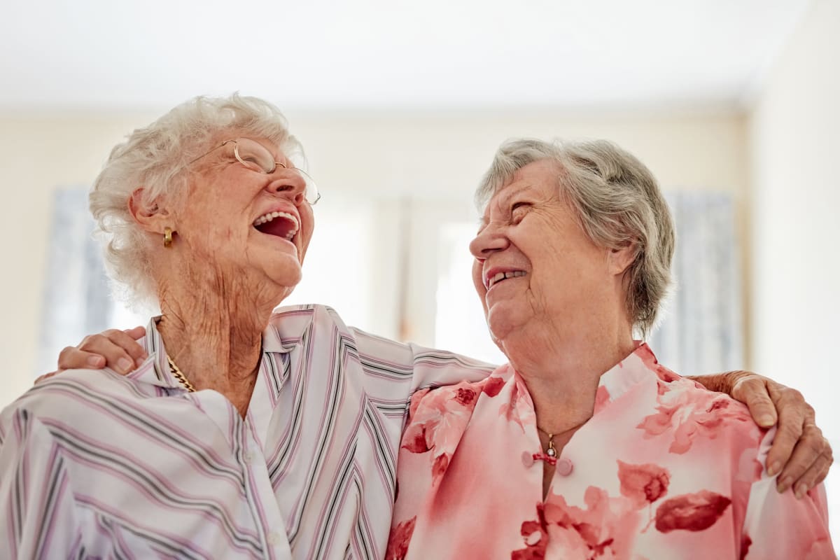 Two residents laughing together at The Oxford Grand Assisted Living & Memory Care in Wichita, Kansas