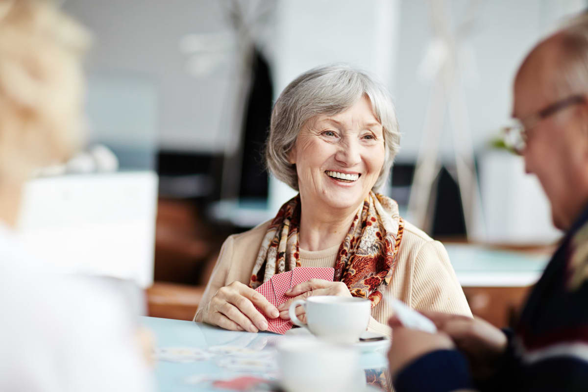 Smiling residents playing cards at Canoe Brook Assisted Living in Wichita, Kansas