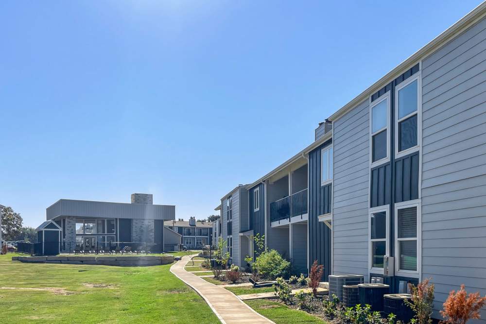 Community building exterior view with grassy lawn at Quail Run in Oklahoma City, Oklahoma 