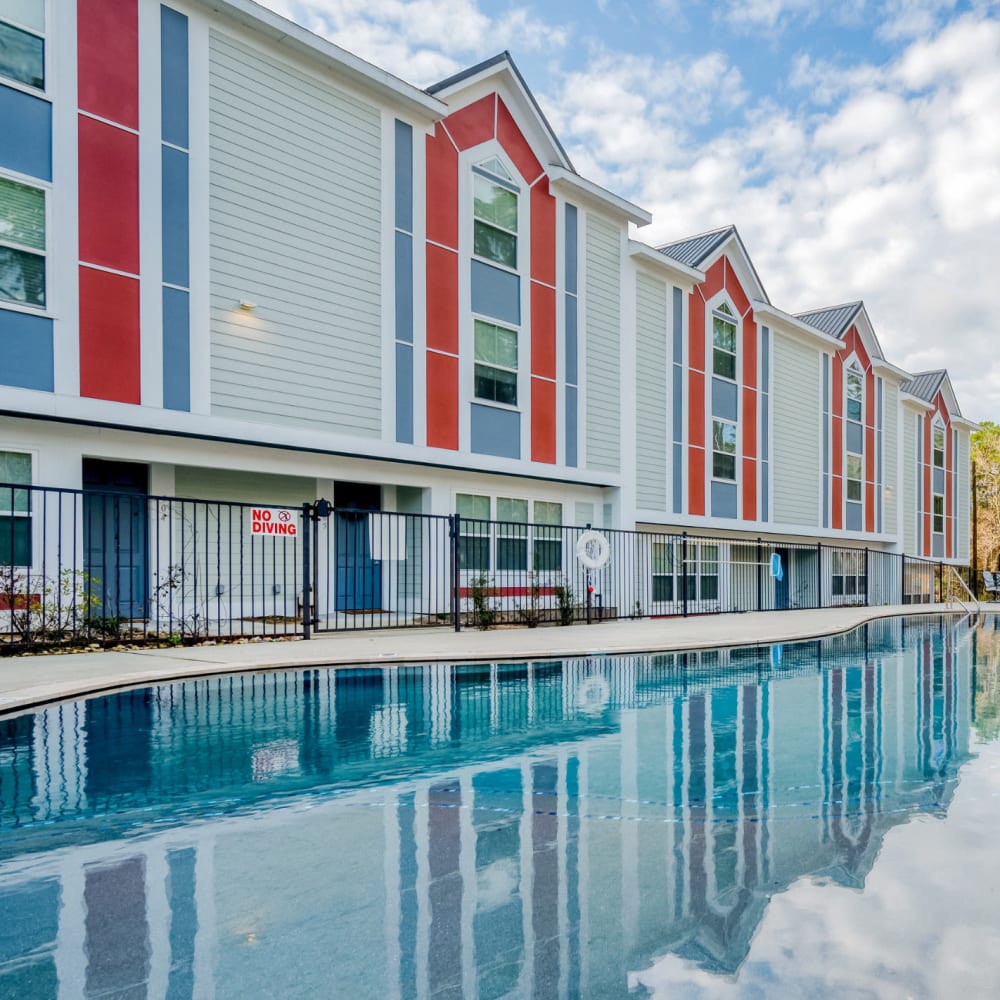Apartments overlooking the sparkling swimming pool at Huntsville Village Apartments in Huntsville, Texas