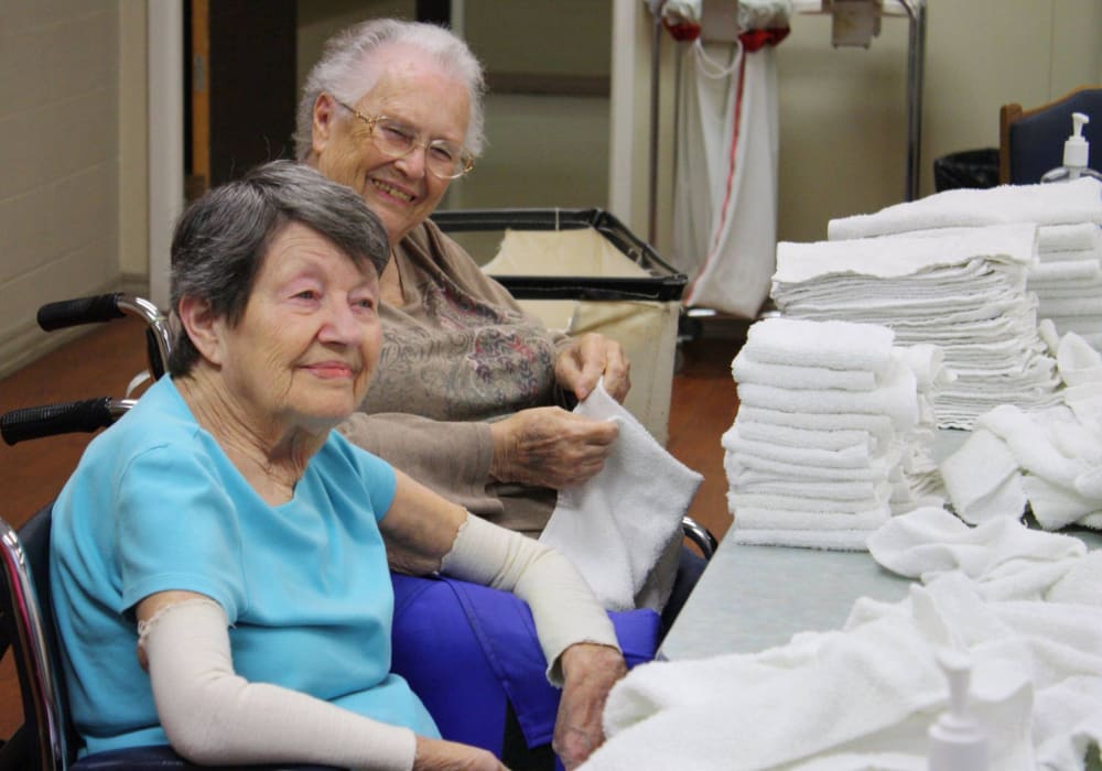 Residents folding towels and clean laundry at Geneva Lake Manor in Lake Geneva, Wisconsin