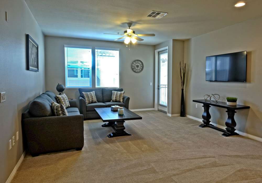 Stylish living room with neutral color palette at Pacific Landing in Murrieta, California