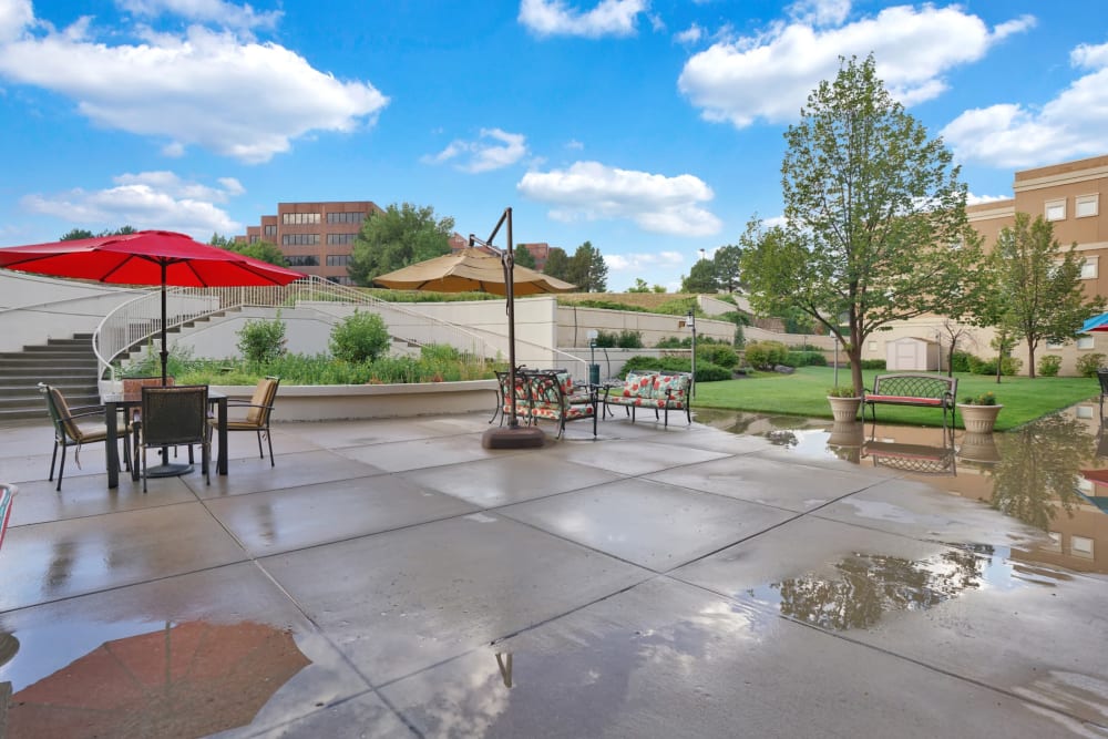 Umbrella covered outdoor seating at The Inn at Greenwood Village in Greenwood Village, Colorado