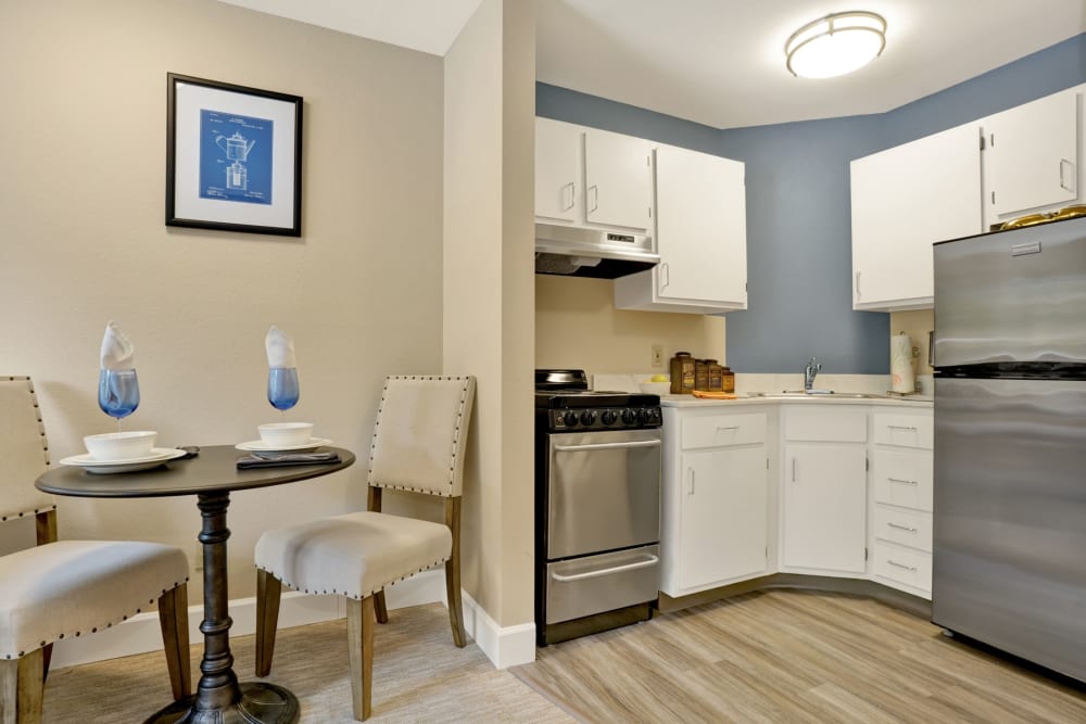 Kitchen with seating in senior living apartment at Mountlake Terrace Plaza in Mountlake Terrace, Washington