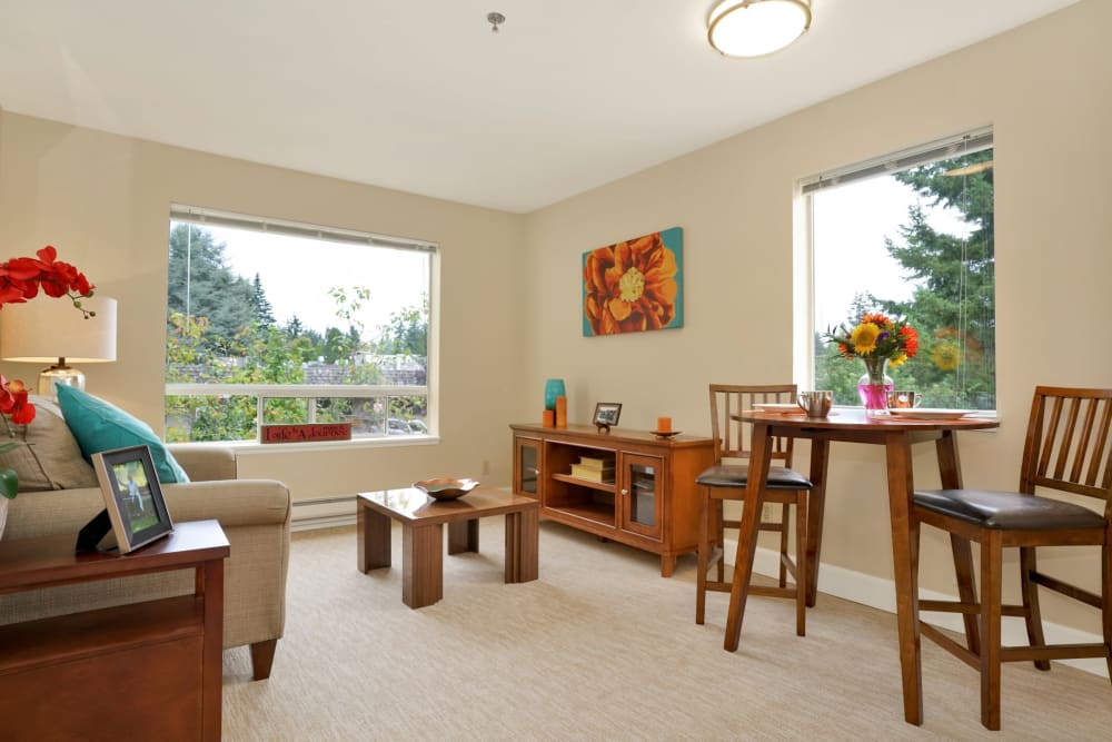 Sitting area with bright window light in apartment at Mountlake Terrace Plaza in Mountlake Terrace, Washington