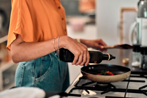 Resident cooking in her kitchen at James River Pointe in Richmond, Virginia