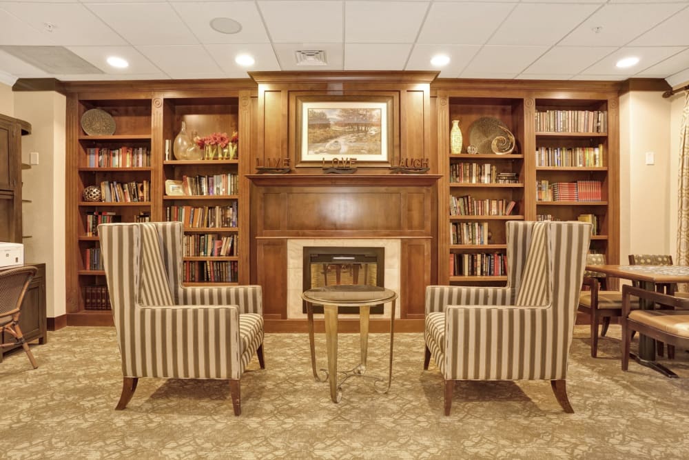 Elegant sitting area with bookcases at The Inn at Greenwood Village in Greenwood Village, Colorado