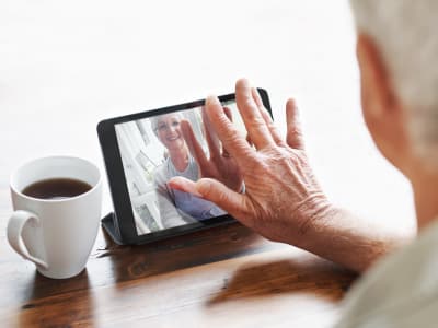 Senior using iPad at Maplewood Senior Living