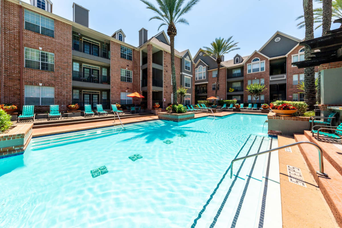 Resort style pool with lunge chairs on deck at Marquis on Pin Oak in Houston, Texas