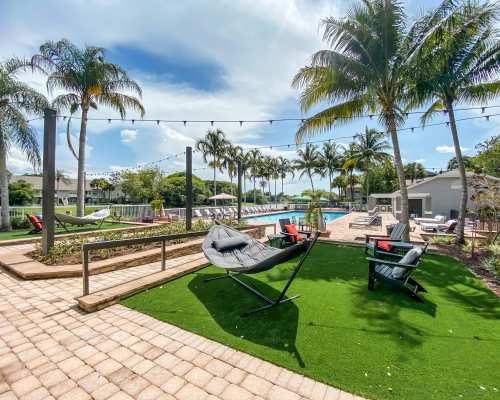 Inviting hammocks and chairs near the pool at Atwater Apartment Homes, Sunrise, Florida