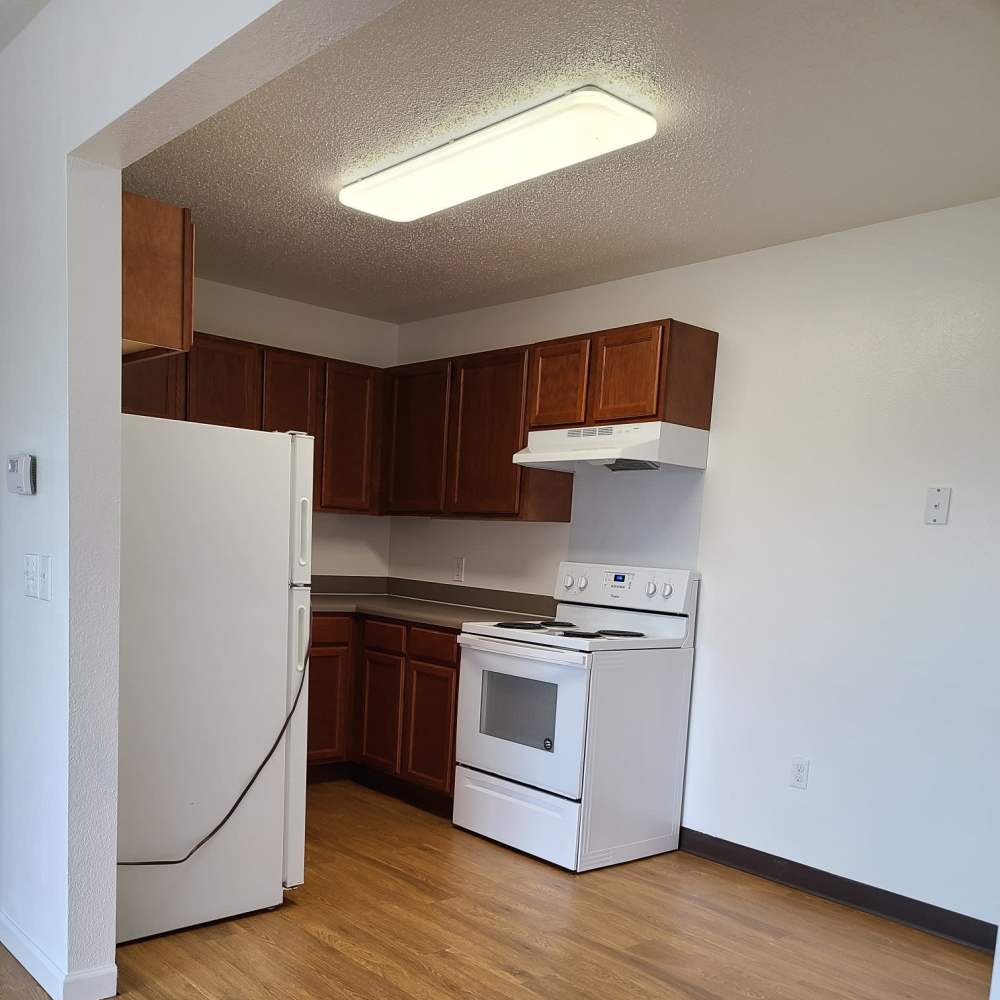 Kitchen with wooden cabinets at Manistique Lakeview in Manistique, Michigan