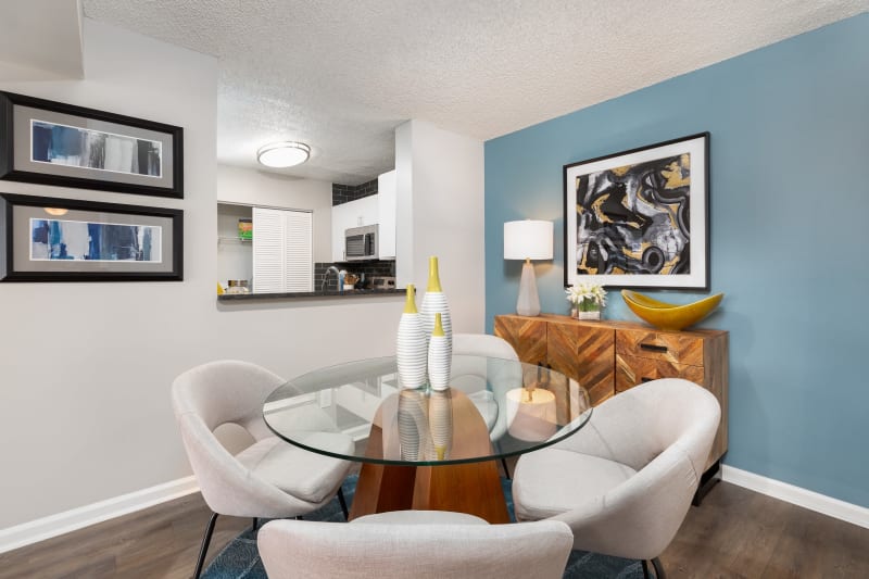 Modern dining area with glass table at The Mason in Ladson, South Carolina