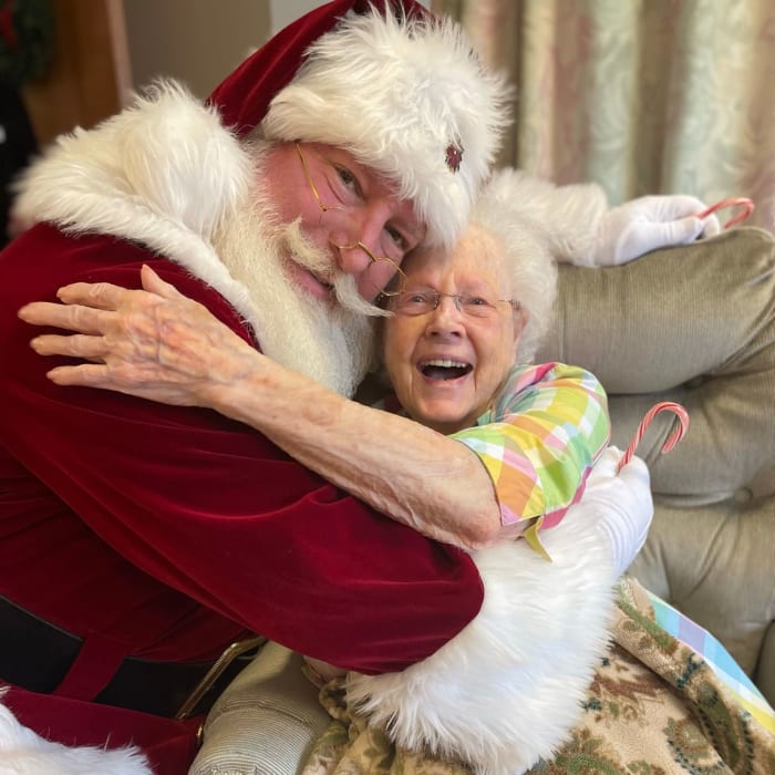 Resident hugging santa at The Columbia Presbyterian Community in Lexington, South Carolina