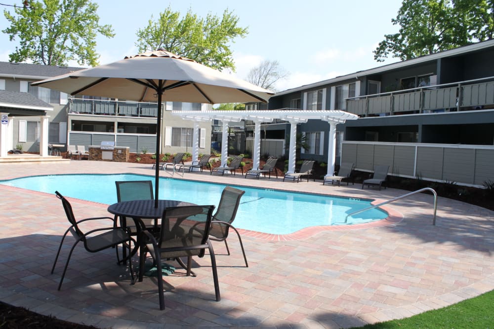 Sparkling pool and picnic area at Pinebrook Apartment Homes in Fremont, California