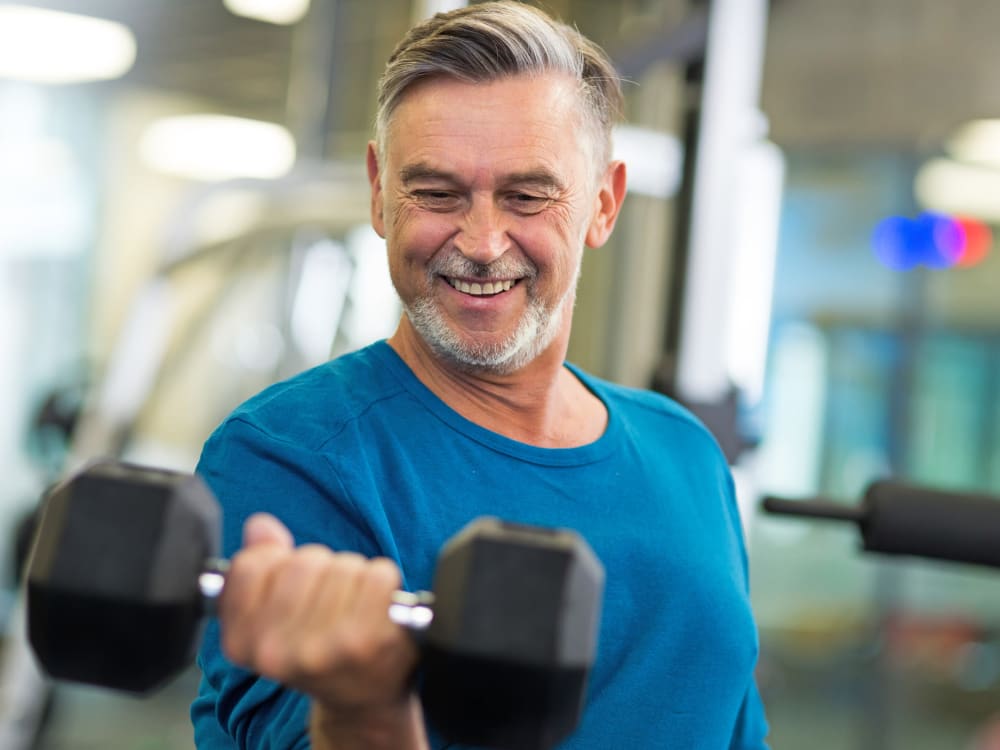 A resident lifting a weight at Touchmark Central Office in Beaverton, Oregon