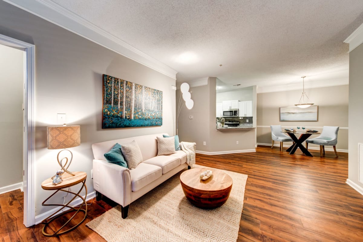 Open living room with wood floors and rug at Marquis on Edwards Mill in Raleigh, North Carolina