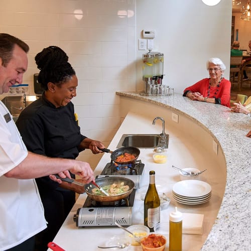 A resident watches chefs cook at Celebration Village Acworth in Acworth, Georgia