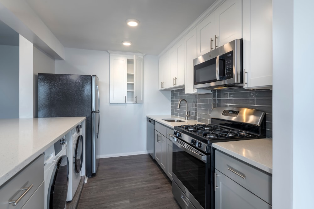 Model kitchen with in-home washer and dryer at Ruxton Towers in Towson, Maryland