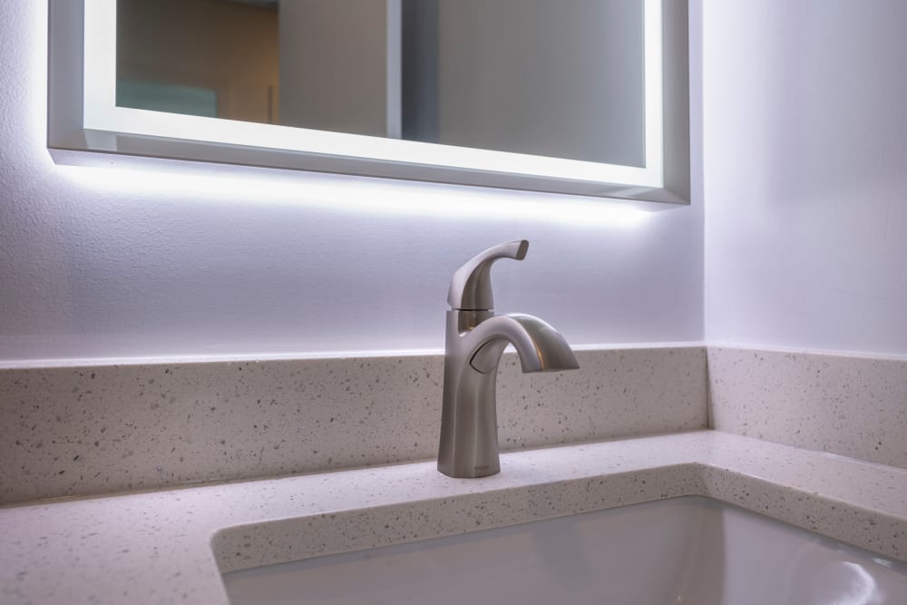 Bathroom sink with backlit mirror at Ruxton Tower in Towson, Maryland