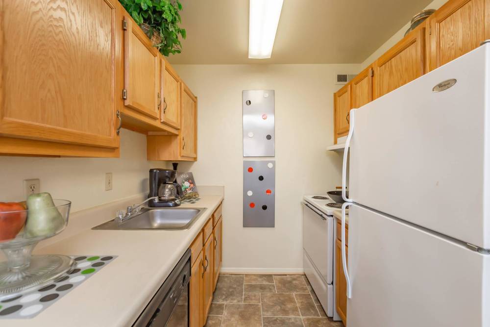 A modern kitchen with white colored appliances at Village at Town Park in Hampton, Virginia