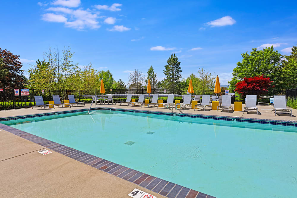 Beautiful resort-style swimming pool with lounge chairs at Cascade Ridge in Silverdale, Washington
