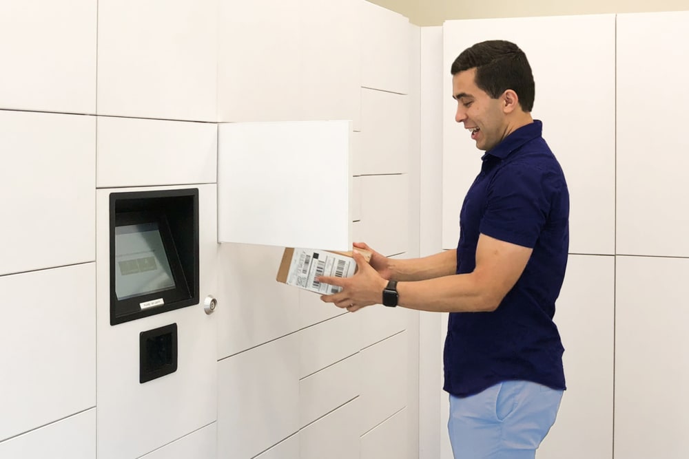 Man picking up a package at Halford Gardens Apartments in Santa Clara, California