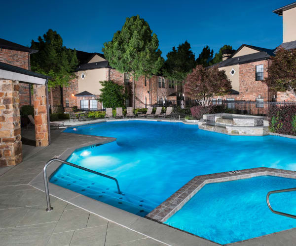 Night view of the swimming pool at Villas at Parkside in Farmers Branch, Texas